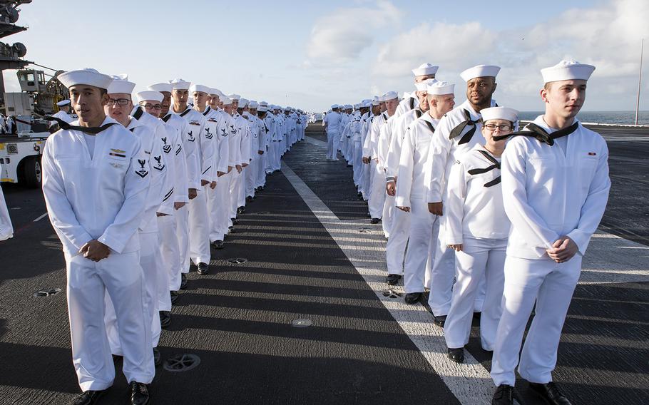 Sailors prepare to man the rails as the aircraft carrier USS Carl Vinson returns to its homeport in San Diego, Calif, Thursday, April 12, 2018.