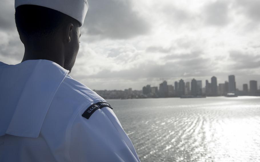 A sailor mans the rails as the aircraft carrier USS Carl Vinson returns to San Diego, Calif., Thursday, April 12, 2018. 