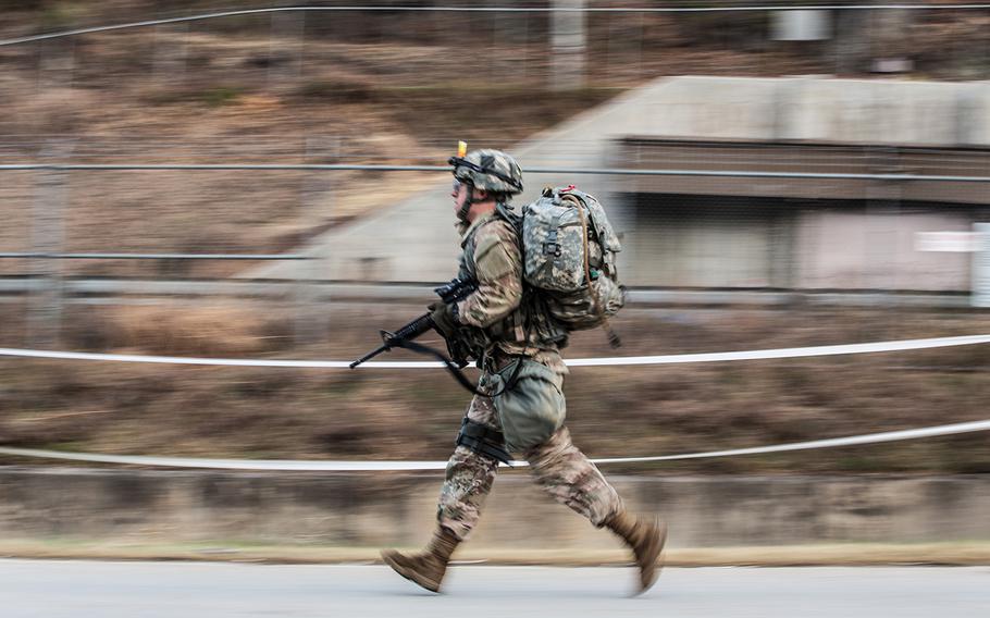 A soldier races from the turn-around point during a 12-mile road march as part of the 2nd Infantry Division's Best Warrior competition at Camp Casey, South Korea, Thursday, April 12, 2018.