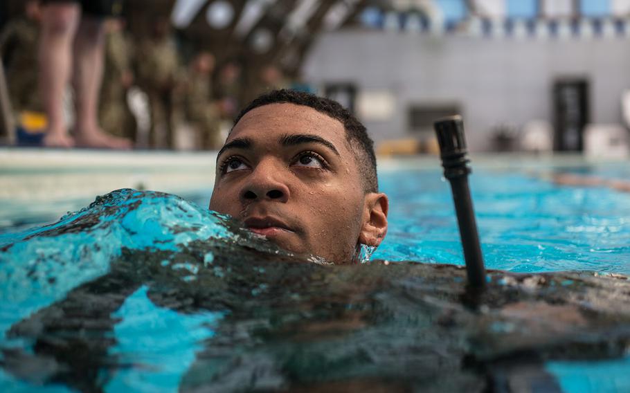 A soldier treads water with his rifle during the 2nd Infantry Division's Best Warrior competition at Camp Hovey, South Korea, Wednesday, April 11, 2018. 