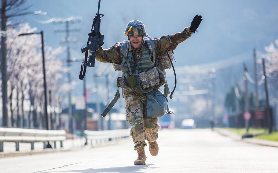 A soldier crosses the finish line at the end of a 12-mile road march during the 2nd Infantry Division's Best Warrior competition at Camp Casey, South Korea, Thursday, April 12, 2018. 