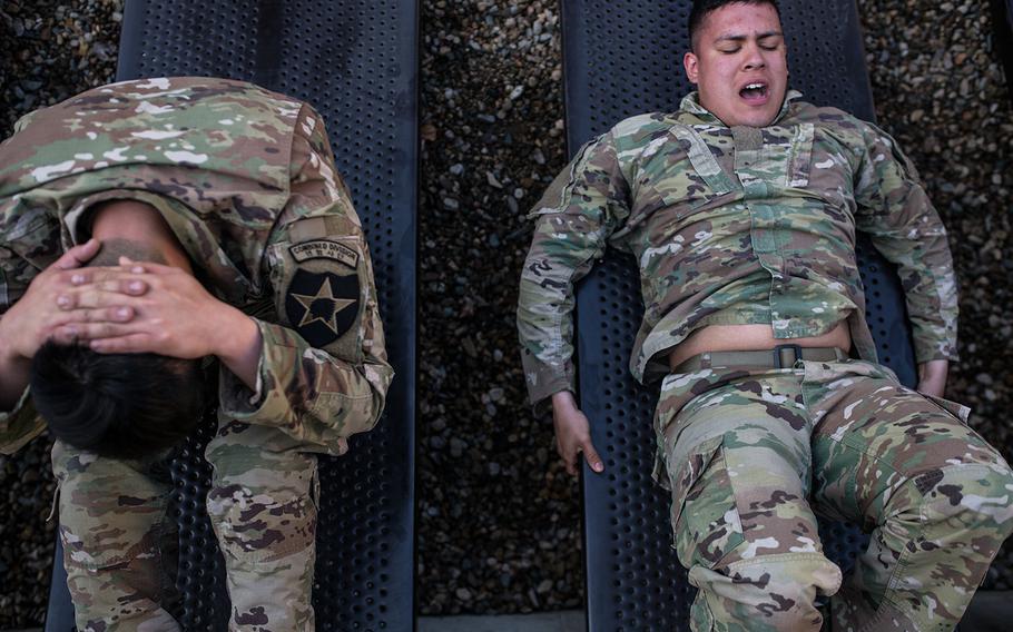 A pair of soldiers squeeze out a few more sit-ups during the 2nd Infantry Division's Best Warrior competition at Camp Casey, South Korea, Wednesday, April 11, 2018. 