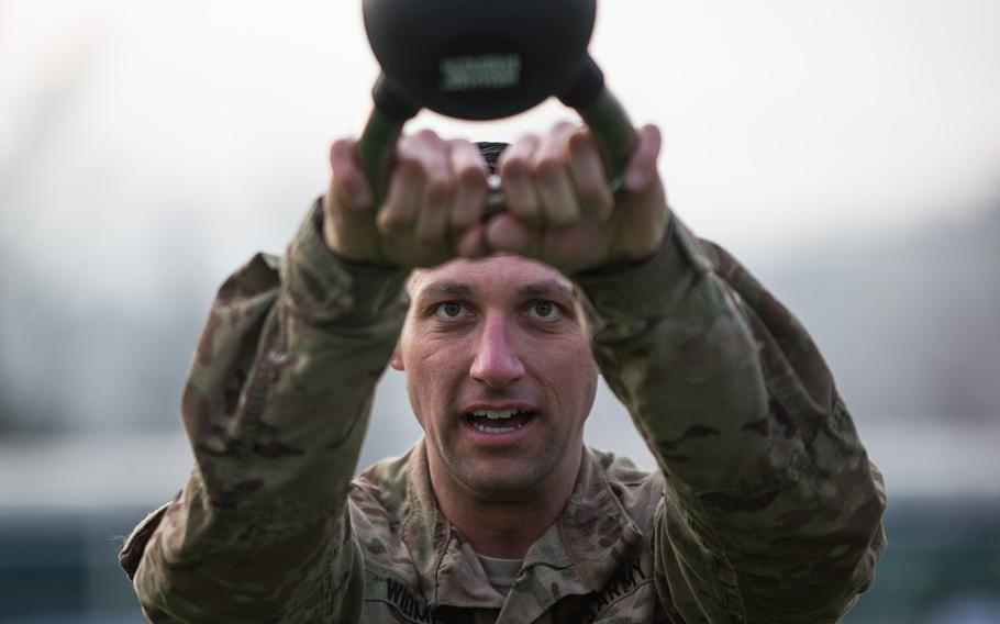 Sgt. 1st Class Terrance Widmer swings a weight during a fitness challenge as part of the 2nd Infantry Division's Best Warrior competition at Camp Casey, South Korea, Wednesday, April 11, 2018. 