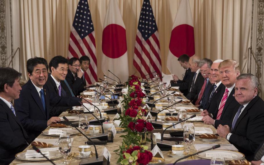 President Donald Trump, right, speaks to members of the media during a working lunch with Japanese Prime Minister Shinzo Abe, left, at Trump's private Mar-a-Lago club, Wednesday, April 18, 2018, in Palm Beach, Fla.