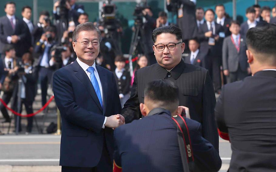 North Korean leader Kim Jong Un shakes hands with South Korean President Moon Jae-in Friday, April 27, 2018 as the two leaders began a historic summit aimed at ridding the communist state of its nuclear weapons. 