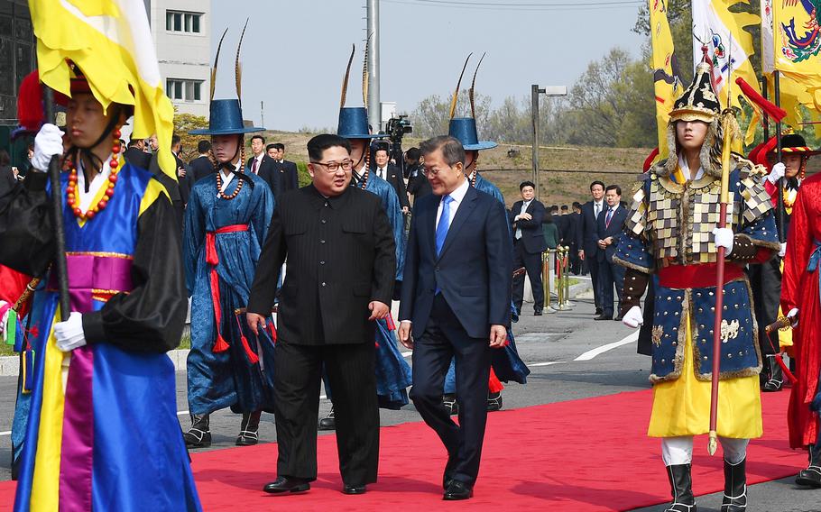 North Korean leader Kim Jong Un walks alongside South Korean President Moon Jae-in Friday, April 27, 2018 as the two leaders began a historic summit aimed at ridding the communist state of its nuclear weapons. 