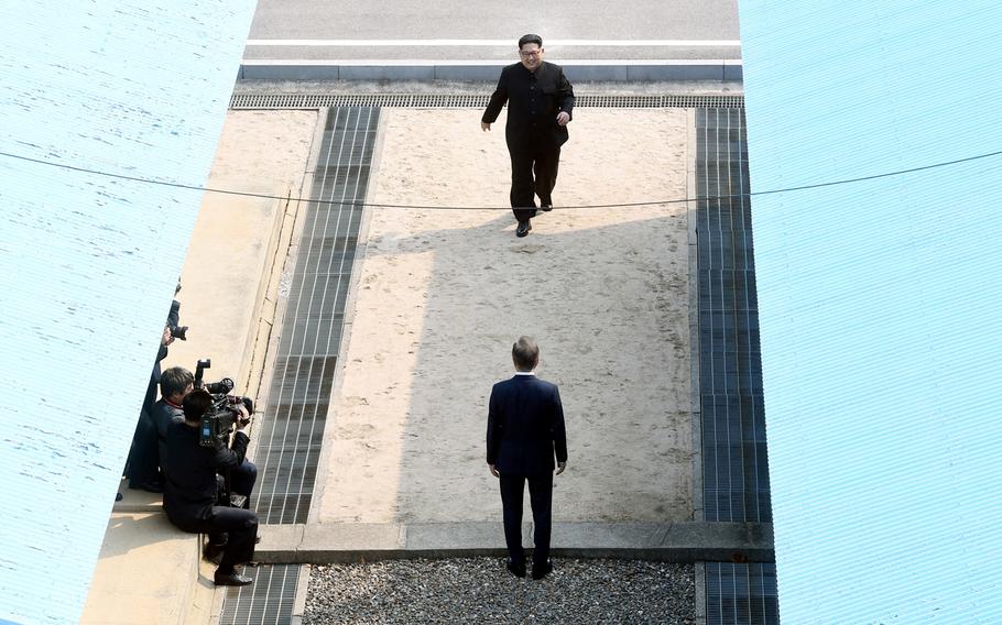North Korean leader Kim Jong Un approaches South Korean President Moon Jae-in Friday, April 27, 2018 as the two leaders began a historic summit aimed at ridding the communist state of its nuclear weapons. 