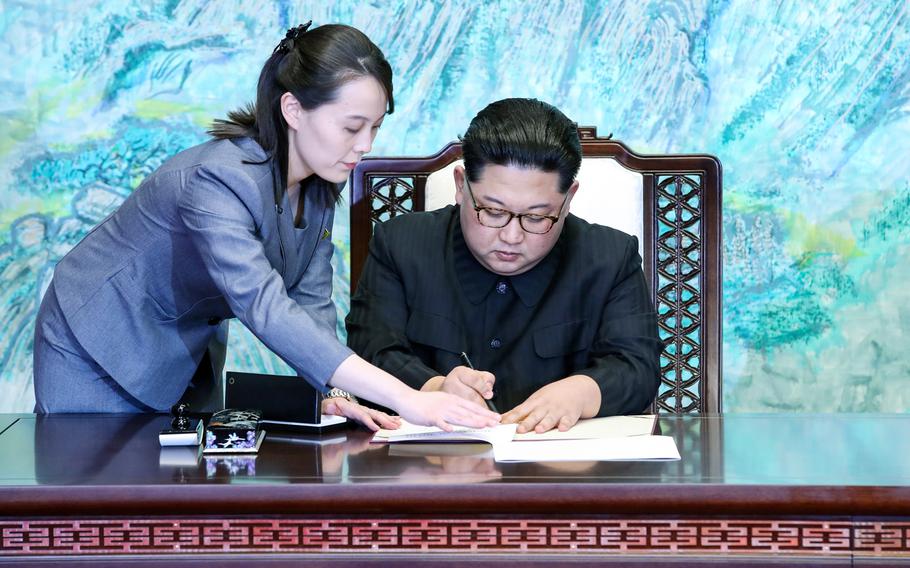 North Korean leader Kim Jong Un, joined by his younger sister, Kim Yo Jong, signs the Panmunjom Declaration during the Inter-Korean Summit on Friday, April 27, 2018.