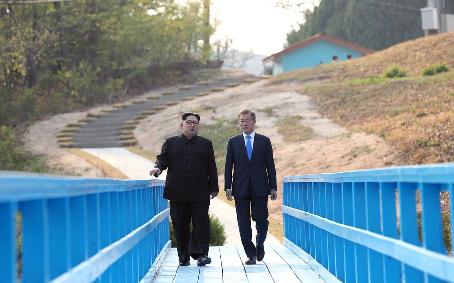 North Korean leader Kim Jong Un, left, walks with South Korean President Moon Jae-in during the Inter-Korean Summit on Friday, April 27, 2018.