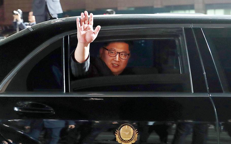 North Korean leader Kim Jong Un waves from a car as he returns to North Korea after the meeting with South Korean President Moon Jae-in at the border village of Panmunjom in the Demilitarized Zone, South Korea, on April 27, 2018.
