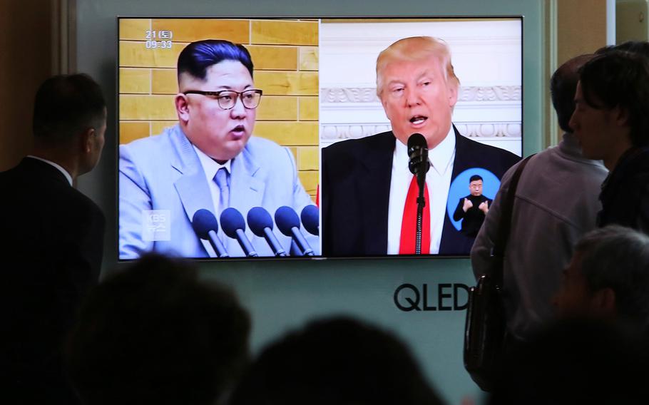 People watch a TV screen showing file footage of U.S. President Donald Trump, right, and North Korean leader Kim Jong Un during a news program at the Seoul Railway Station in Seoul, South Korea, on April 21, 2018.