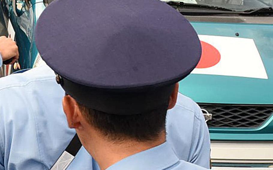 As about 1,500 people gathered in front of the Okinawan Prefectural Government offices in Naha to protest a security bill endorsed by Prime Minister Shinzo Abe, Japanese police officers surround ultra-right wing protesters who support Abe and were trying to gain attention by playing loud music and yelling through a loudspeaker around the protesters on July 31, 2015. (Tiffany Tompkins-Condie/McClatchy DC/TNS)