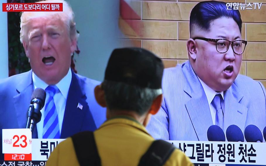 a man watches a TV screen at the Seoul Railway Station in Seoul, South Korea, on May 13, 2018, during a news program showing U.S. President Donald Trump, left, and North Korean leader Kim Jong Un.