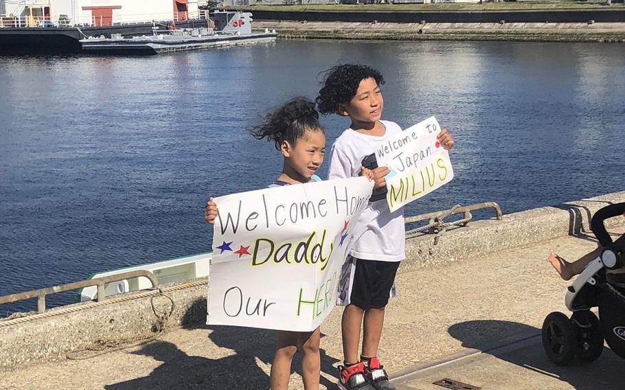 Kianna Brown, 5, and Tavion Brown, 7, await their father’s arrival at Yokosuka Naval Base, Japan, Tuesday, May 22, 2018. Their father, Chief Petty Officer Kevin Brown, serves aboard the USS Milius, which is the latest ship to join the Navy’s 7th Fleet.