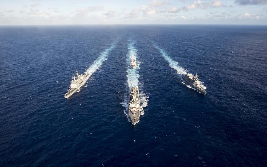The guided-missile destroyer USS Mustin (DDG 89) leads the guided-missile cruiser USS Antietam (CG 54), the guided-missile destroyer USS Curtis Wilbur (DDG 54) and the Japan Maritime Self-Defense Force ship JS Fuyuzuki (DD 118) in a formation during a training exercise in March 2018 in the Philippine Sea. 