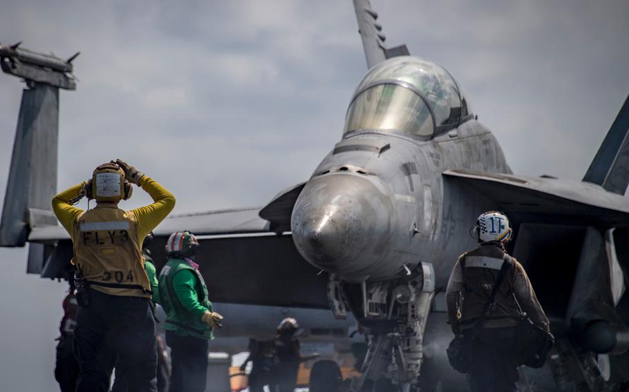 Sailors perform flight operations aboard the Nimitz-class aircraft carrier USS Carl Vinson (CVN 70), in the South China Sea on March 13, 2018.