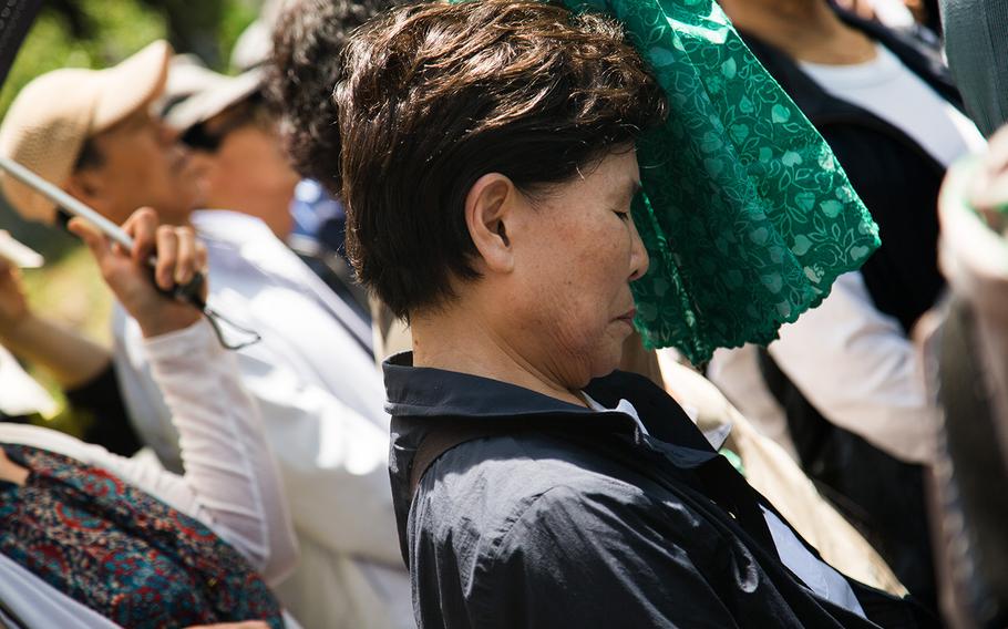 A South Korean women pays her respects to fallen U.S. servicemembers at Yanghwajin Cemetery in Seoul, South Korea, Monday, May 28, 2018. 