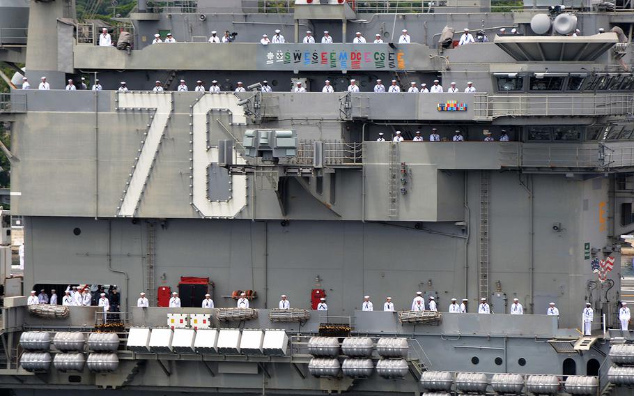 Sailors man the rails of the aircraft carrier USS Ronald Reagan (CVN 76) as it departs U.S. Fleet Activities Yokosuka on May 29, 2018.