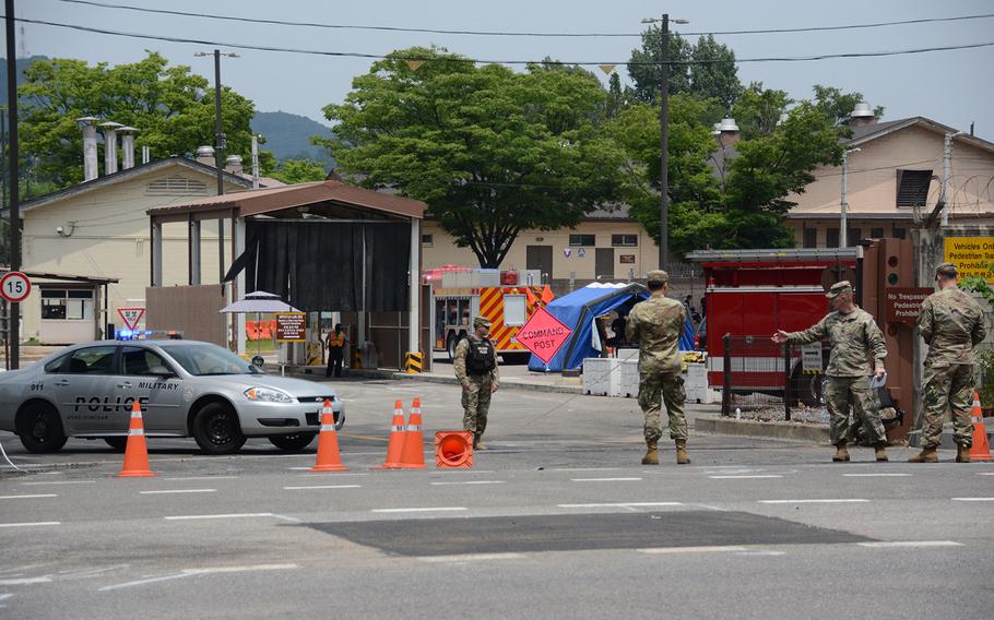 Military Police investigate the site of a fatal car crash outside Gate 13 at Yongsan Garrison in Seoul, South Korea, on Saturday, June 9, 2018. 