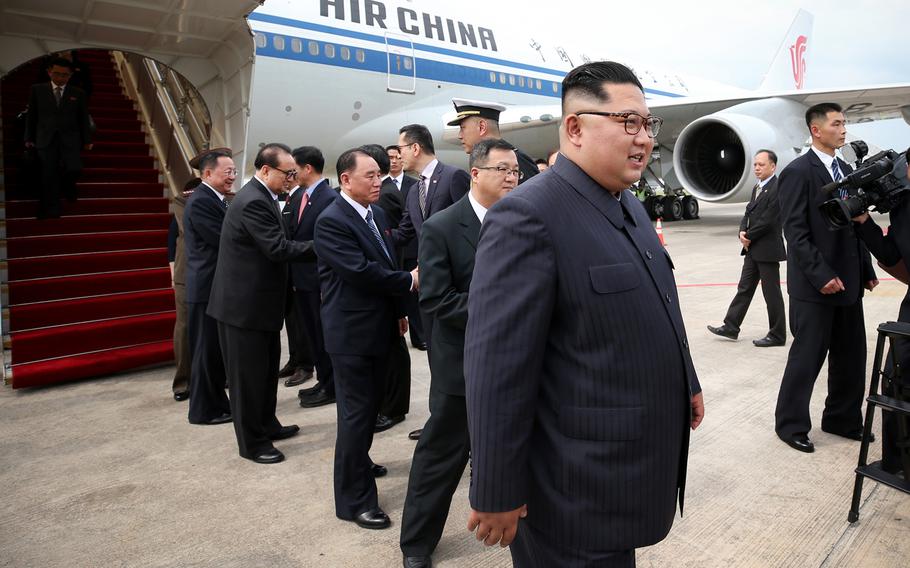 North Korean leader Kim Jong Un, along with several North Korean diplomats, arrives at Singapore's Changi Airport, June 10, 2018.