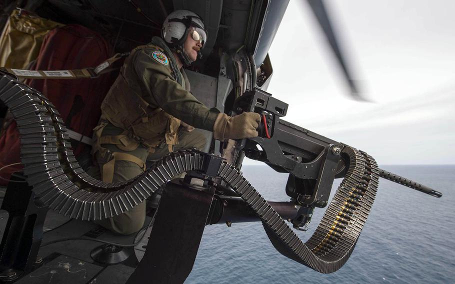A sailor prepares to shoot a target with a .50-caliber machine gun during a gunnery exercise with the Royal Thai Navy during Cooperation Afloat Readiness and Training 2017 in Thailand.