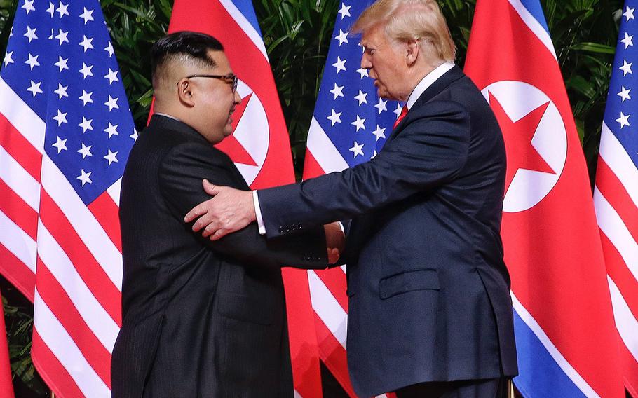 North Korean leader Kim Jong Un shakes hands with President Donald Trump in Singapore on June 12, 2018.