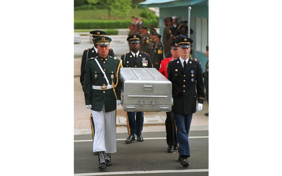 U.N. honor guards carry a coffin containing the remains of U.S. soldiers after it was returned from North Korea at the border village of Panmunjom, South Korea, on May 14, 1999. South Korean media reported that the U.S. military plans to send 215 caskets to North Korea through a border village on Saturday, June 23, 2018.