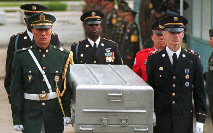 FILE- In this May 14, 1999, file photo, U.N. honor guards carry a coffin containing the remains of the American soldiers after it was returned from North Korea at the border village of Panmunjom, South Korea. South Korean media reported that the U.S. military plans to send 215 caskets to North Korea through a border village on Saturday, June 23, 2018, so that the North could begin the process of returning the remains of U.S. soldiers who have been missing since the 1950-53 Korean War. (AP Photo/Ahn Young-joon, File)