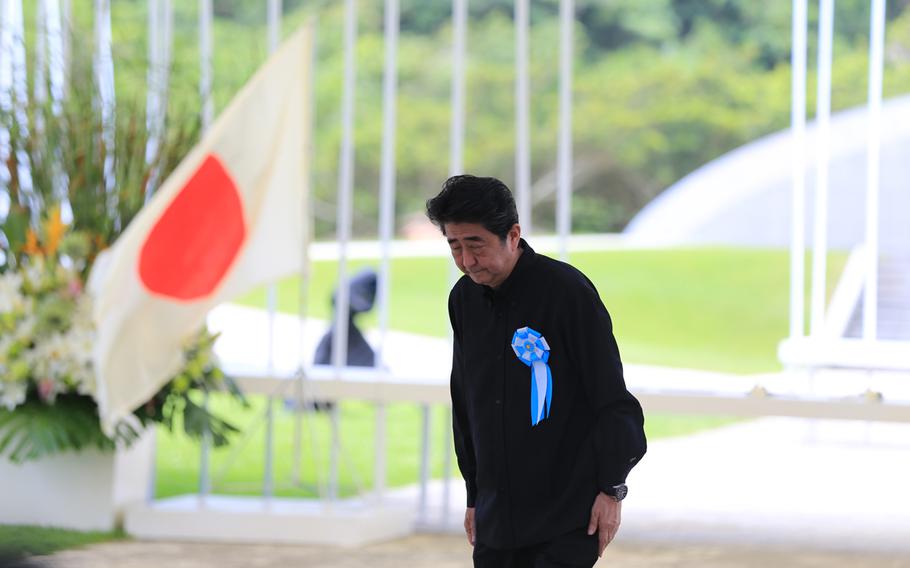 Japan's Prime Minister Shinzo Abe bows during the annual Irei no Hi ceremony, commemorating the 73rd anniversary of the Battle of Okinawa on Saturday, June 23, 2018.