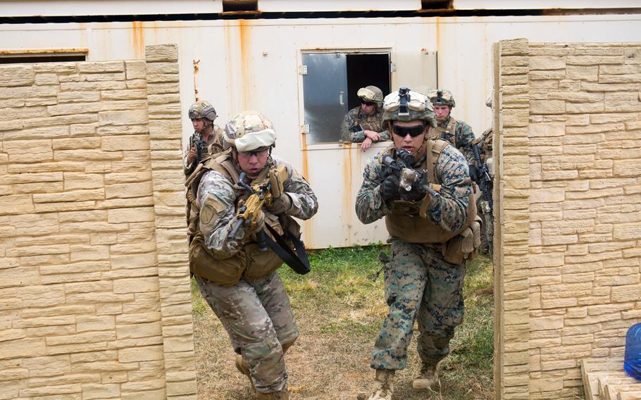 A Chilean and U.S. Marine practice clearing a room together during urban operations training as part of Rim of the Pacific exercise at Marine Corps Base Hawaii, June 28, 2018.
