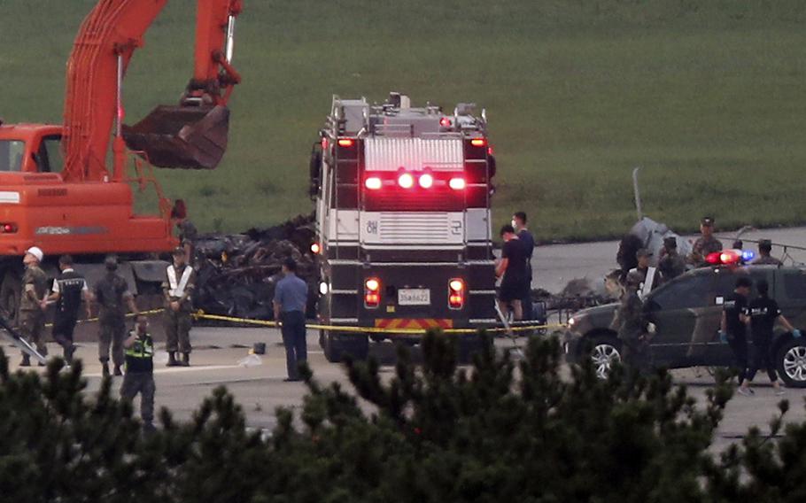 South Korean officials inspect a runway at an airport in Pohang, South Korea, where five people were killed Tuesday, July 17, 2018, in a helicopter crash, the Defense Ministry said.