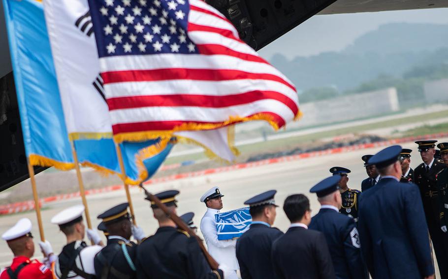 A case of remains repatriated from North Korea is carried off a C-17 Globemaster at Osan Air Base, South Korea, Friday, July 27, 2018.