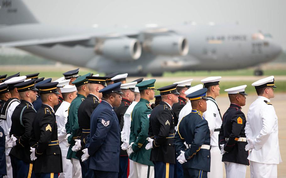 Honor Guard members wait as an aircraft carrying 55 sets of remains handed over by North Korea arrives at Osan Air Base, South Korea, Friday, July 27, 2018.