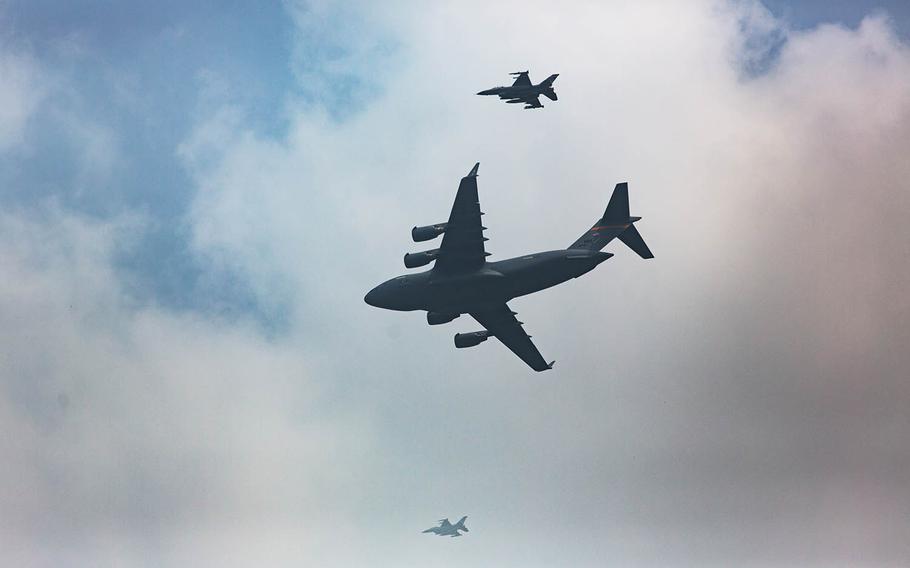 Escorted by fighter jets, a C-17 Globemaster arrives at Osan Air Base, South Korea, carrying 55 sets of remains handed over by North Korea, Friday, July 27, 2018.