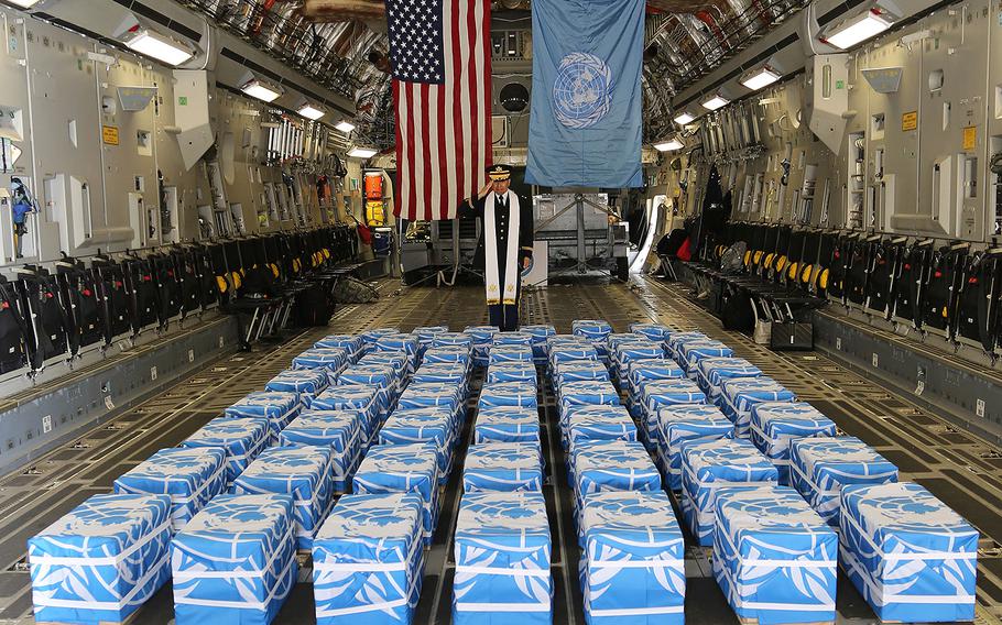 United Nations Command Chaplain U. S. Army Col. Sam Lee performs a blessing over 55 cases of remains returned by North Korea at Osan Air Base on Friday, July 27, 2018.