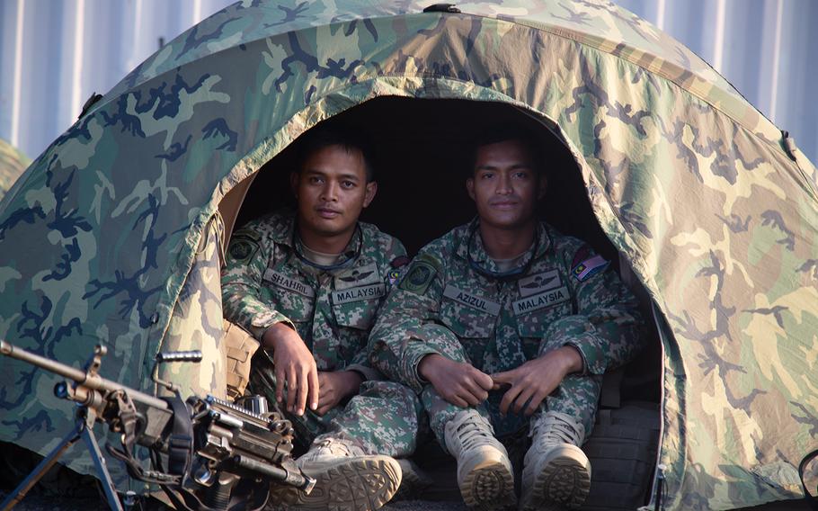 A pair of Malaysian Marines pose in their tent at Pohakuloa Training Area, Hawaii during the Rim of the Pacific exercise, July 15, 2018.