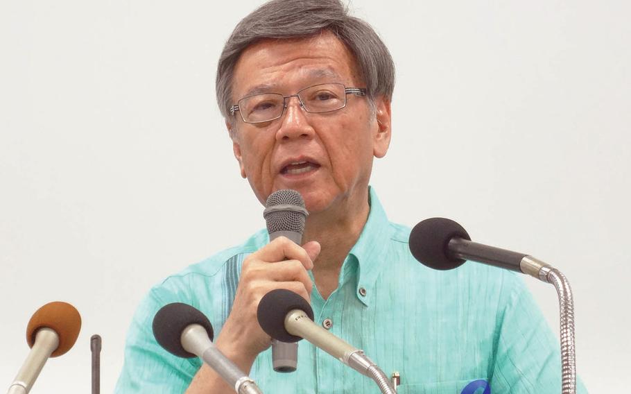 Okinawa Gov. Takeshi Onaga speaks to reporters during a rally in 2015 against a plan to move Marine Corps air operations from urban Futenma to the island's remote north.