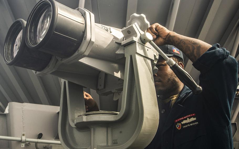 In an Aug. 11, 2018 file photo, Boatswain's Mate 3rd Class Travis McIver stands a lookout watch aboard the USS Essex during search and rescue operations for a missing Marine assigned to the 13th Marine Expeditionary Unit (MEU).