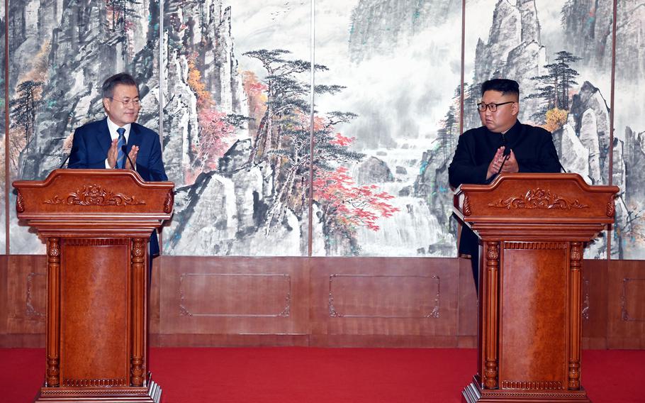 South Korean President Moon Jae-in, left, and North Korean leader Kim Jong Un clap during a joint press conference at the Paekhwawon State Guesthouse in Pyongyang, North Korea on Wednesday, Sept. 19, 2018.