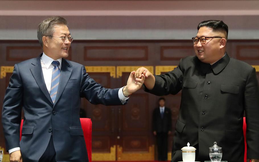 South Korean President Moon Jae-in and North Korean leader Kim Jong Un hold their hands together after watching the mass games performance of "The Glorious Country" at May Day Stadium in Pyongyang, North Korea, Wednesday, Sept. 19, 2018.