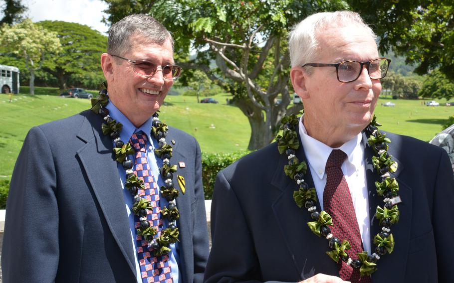 Brothers Charles (left) and Larry McDaniel stand beside a memorial wall holding the name of their father at the National Memorial Cemetery of the Pacific, Sept. 21, 2018.