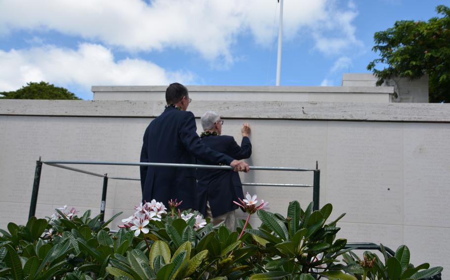 Larry McDaniel places a bronze rosette beside the name of his father, Charles McDaniel, Sr., Sept. 21, 2018, at the Punchbowl Cemetery, indicating that the Korean War Army medic is no longer missing in action.