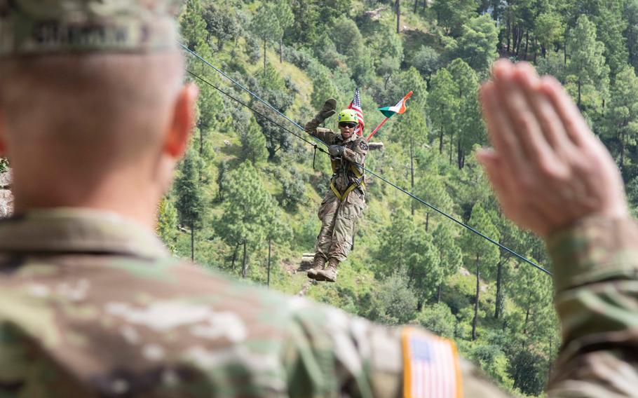 Spc. Sierra Hill, 1-2 Stryker Brigade Combat Team, takes the oath of enlistment on a zipline at Chaubattia Military Station, India, Sept. 25, 2018. 