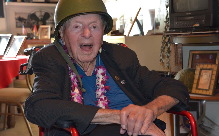 Sidney Walton, 99, poses in a World War II Army helmet at the Home of the Brave Museum in Honolulu, Oct. 5, 2018, just one stop in his 50-state No Regrets Tour.