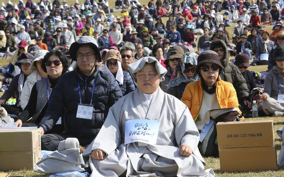 Buddhist believers attend the Demilitarized Zone World Peace Meditation Event at Imjingak Pavilion in Paju near the demilitarized zone of Panmunjom, South Korea, Saturday, Oct. 13, 2018. Thousands of Buddhists believers prayed for peace and denuclearization on the Korean Peninsula. 
