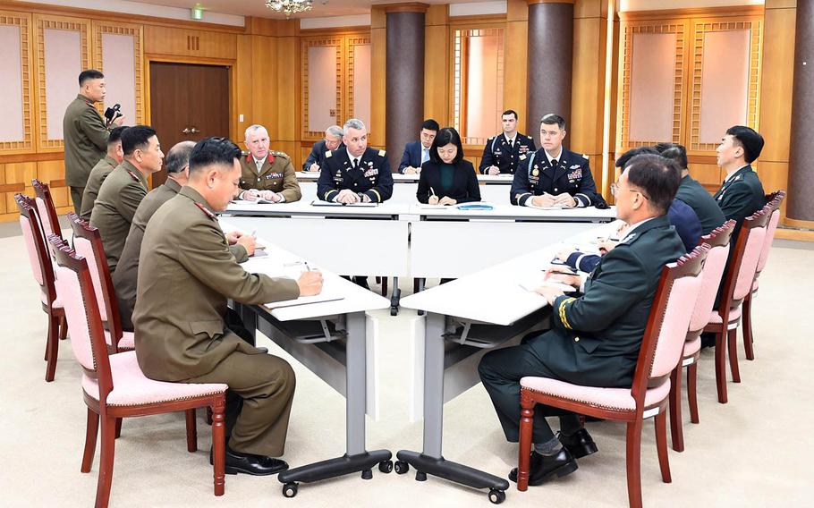 Army Col. Burke Hamilton, secretary of the United Nations Command's military armistice committee, joins North and South Korean military officials during the first trilateral meeting on disarming the border area. The meeting was held on the South Korean side of Panmunjom, Tuesday, Oct. 16, 2018. 