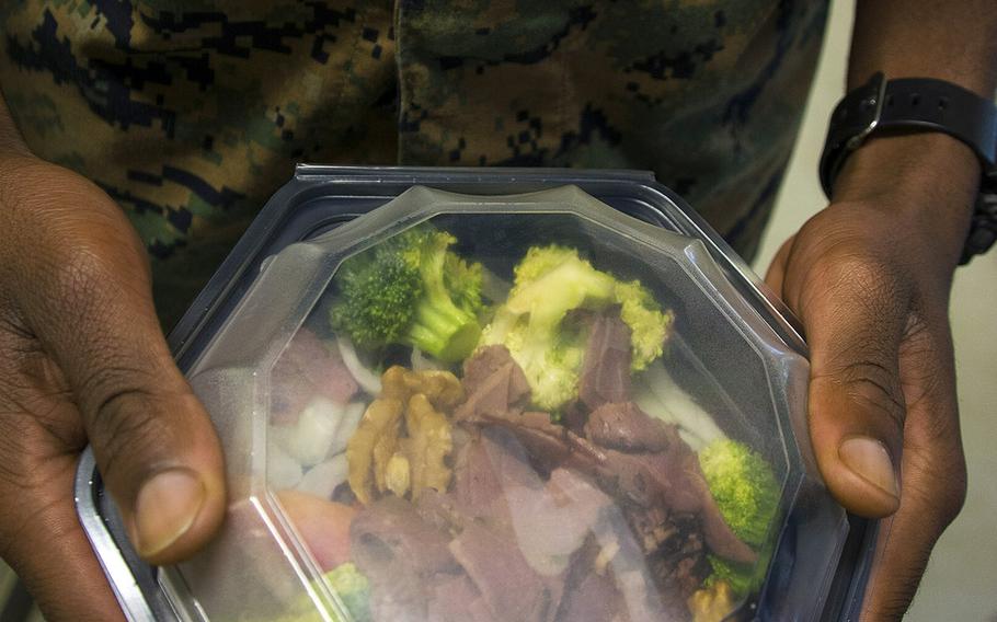 A Marine chooses a salad from the new Fresh Line menu at the 12th Marines Mess Hall at Camp Hansen, Okinawa, Friday, Oct. 12, 2018.