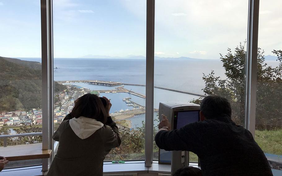 Visitors check out the Russian-held Kunashiri Island from an observatory on the northern Japanese island of Hokkaido. 