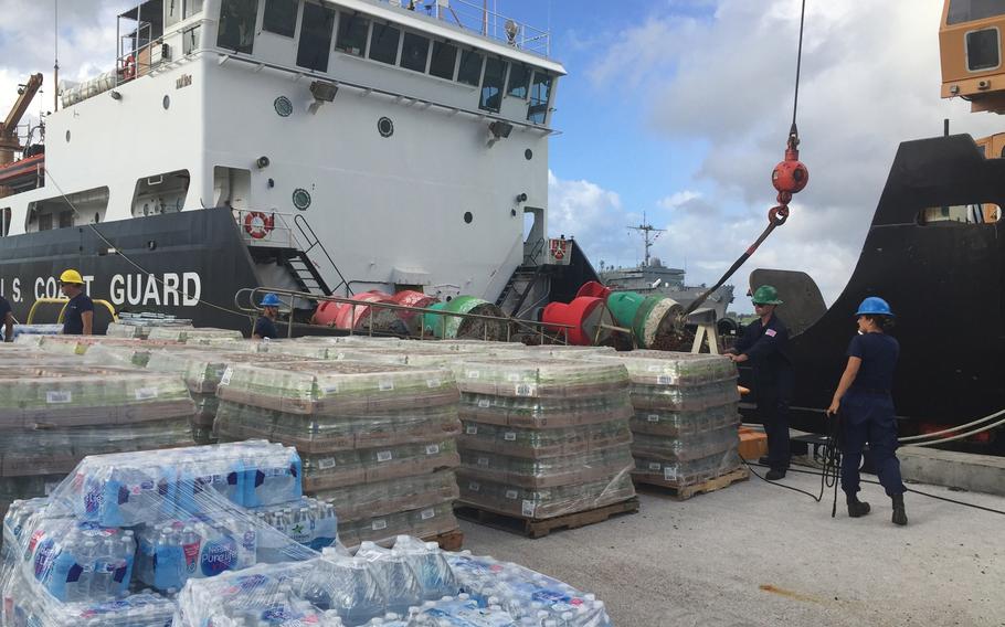 Crewmembers from U.S. Coast Guard cutter Sequoia load supplies in Guam for delivery to Saipan, Friday, Oct. 26, 2018.