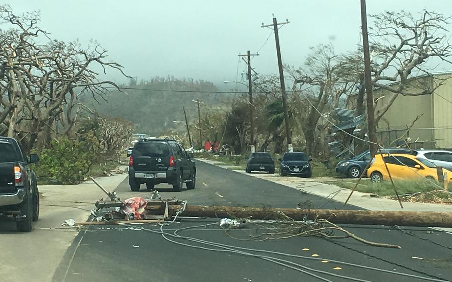 A downed utility pole in the road left by Typhoon Yutu as it passed through Saipan Thursday, Oct. 25, 2018. 